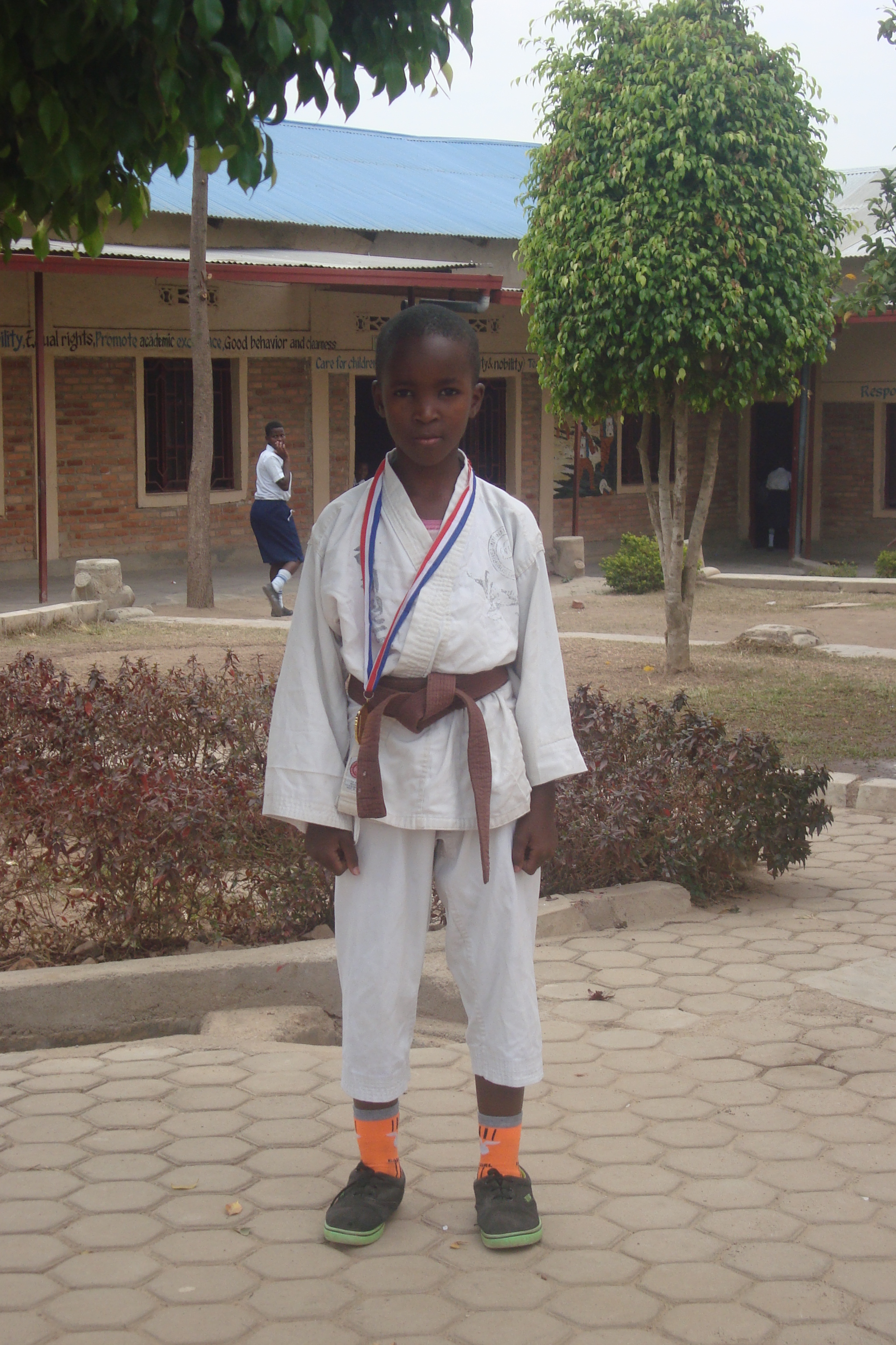 A young BBF Karate Club member wearing his championship medal